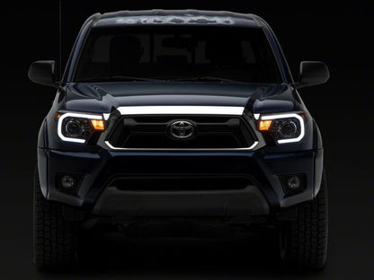 Raxiom 12-15 Toyota Tacoma Axial Projector Headlights w/ SEQL LED Bar- Black Housing (Clear Lens)