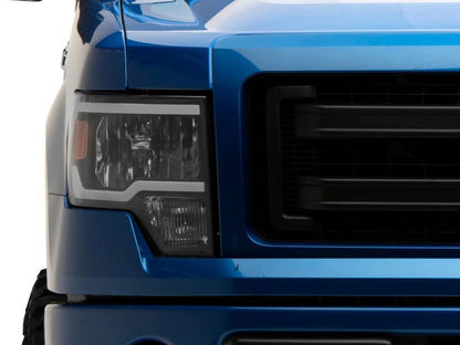 Raxiom 09-14 Ford F-150 Axial Series Headlights w/ LED Bar- Black Housing (Clear Lens)