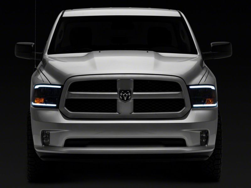Raxiom 09-18 Dodge RAM 1500/2500/3500 Axial Series Headlights w/ LED Bar- Black Housing (Clear Lens)