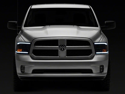 Raxiom 09-18 Dodge RAM 1500/2500/3500 Axial Series Headlights w/ LED Bar- Black Housing (Clear Lens)