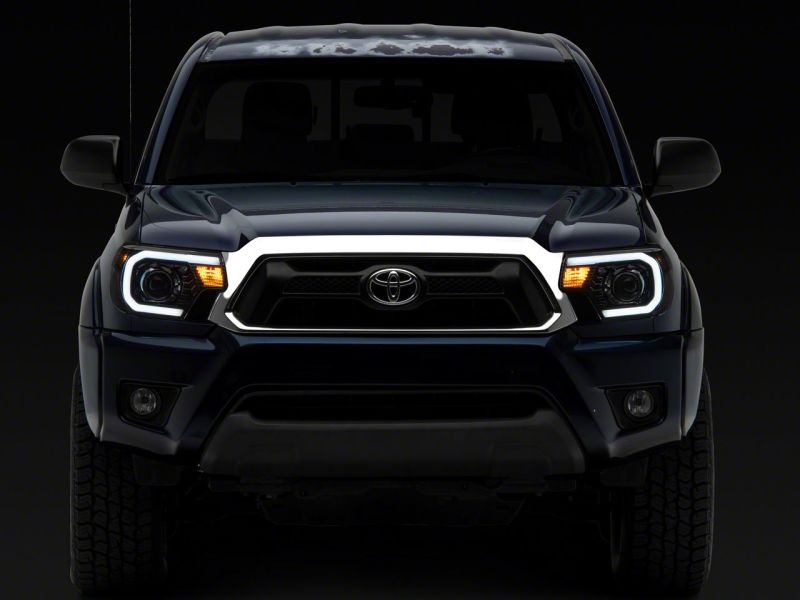 Raxiom 12-15 Toyota Tacoma Axial Series Projector Headlights w/ LED Bar- Black Housing (Clear Lens)