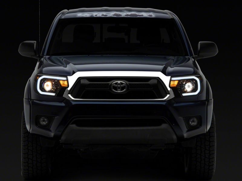 Raxiom 12-15 Toyota Tacoma Axial Series Projector Headlights w/ LED Bar- Black Housing (Clear Lens)