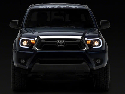 Raxiom 12-15 Toyota Tacoma Axial Projector Headlights w/ SEQL LED Bar- Black Housing (Clear Lens)