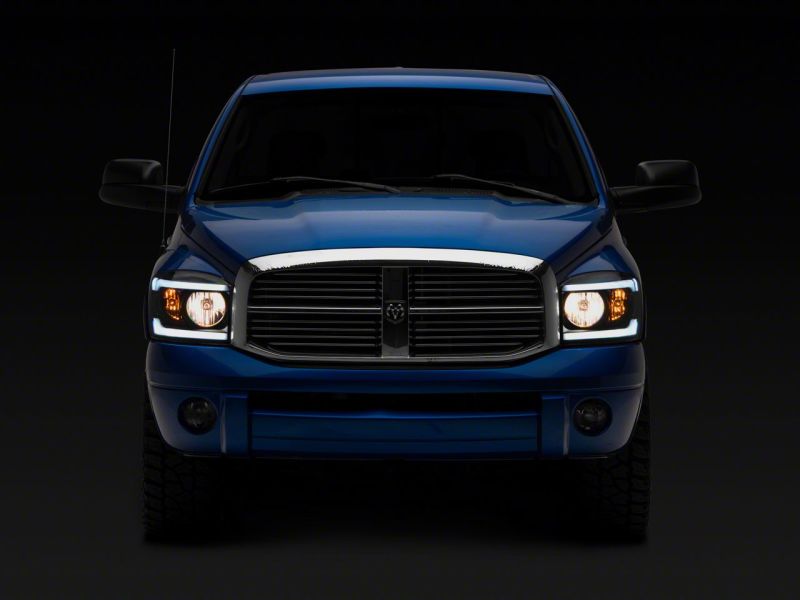 Raxiom 06-09 Dodge RAM 1500/2500/3500 Axial Headlights w/ SEQL LED Bar- Black Housing (Clear Lens)