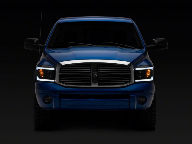 Raxiom 06-09 Dodge RAM 1500/2500/3500 Axial Headlights w/ SEQL LED Bar- Black Housing (Clear Lens)