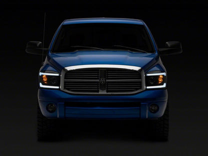 Raxiom 06-09 Dodge RAM 1500/2500/3500 Axial Headlights w/ SEQL LED Bar- Black Housing (Clear Lens)