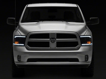 Raxiom 09-18 Dodge RAM 1500/2500/3500 Axial Headlights w/ SEQL LED Bar- Black Housing (Clear Lens)